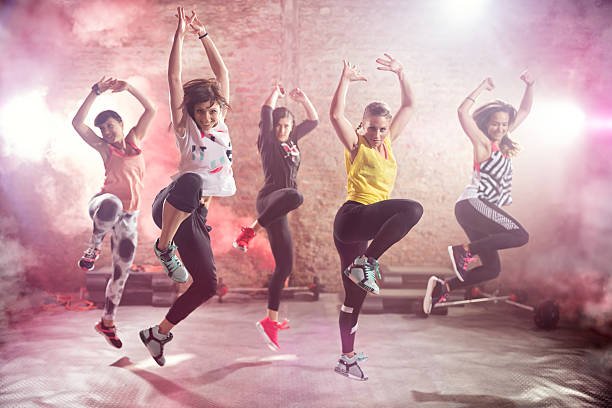 group of fit young women dancing and exercising